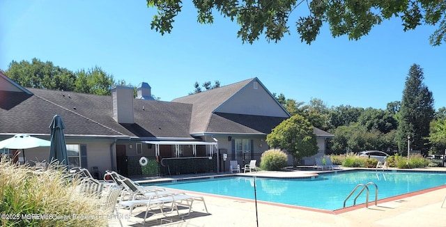 pool featuring a patio area and fence