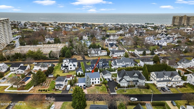 drone / aerial view with a water view and a residential view