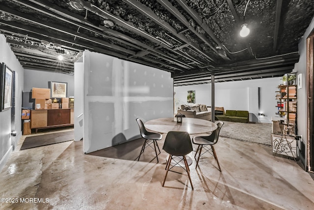 dining space featuring concrete flooring