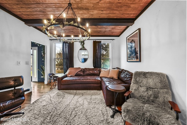 living room featuring beam ceiling, wood finished floors, wood ceiling, and baseboards