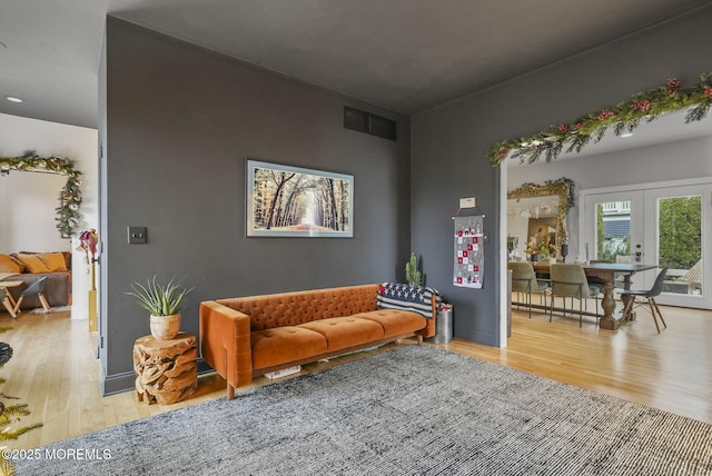 interior space featuring french doors, visible vents, and light wood-style floors