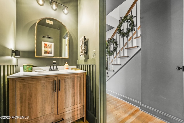 bathroom featuring vanity, baseboards, and wood finished floors