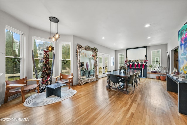 dining space featuring light wood finished floors, french doors, and recessed lighting