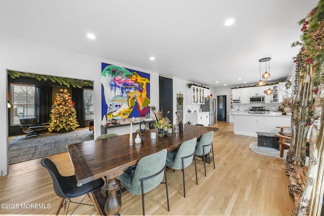 dining area with recessed lighting and light wood-style flooring