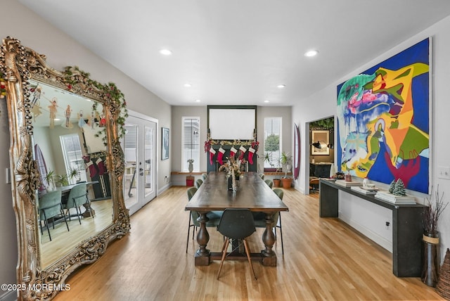 dining room with light wood-style floors, recessed lighting, and french doors