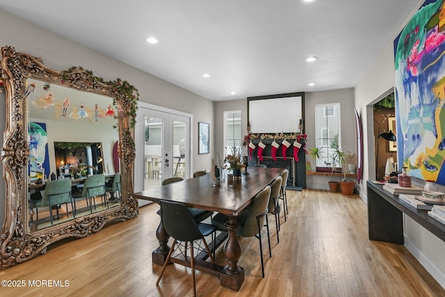 dining area with recessed lighting, light wood finished floors, plenty of natural light, and french doors