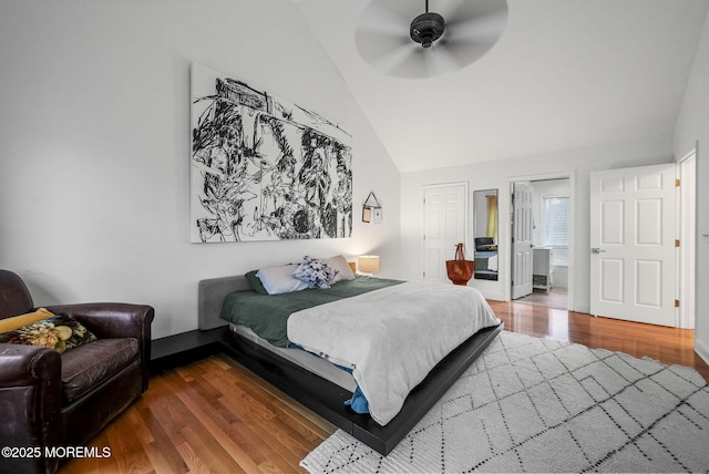 bedroom with ceiling fan, high vaulted ceiling, and wood finished floors