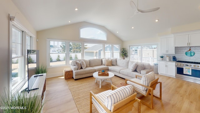 living area featuring light wood-type flooring, vaulted ceiling, a ceiling fan, and recessed lighting