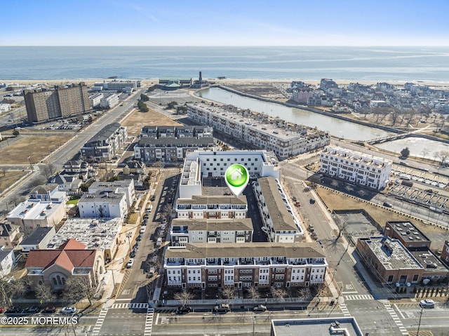 drone / aerial view featuring a view of city and a water view