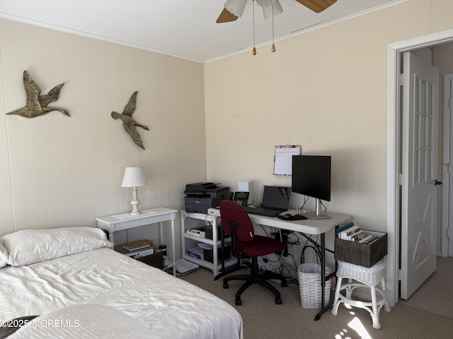 carpeted bedroom featuring ornamental molding and a ceiling fan