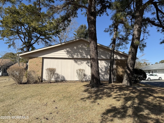 view of home's exterior with a yard and brick siding