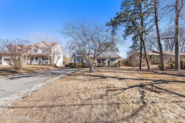 view of front facade featuring a front lawn and aphalt driveway