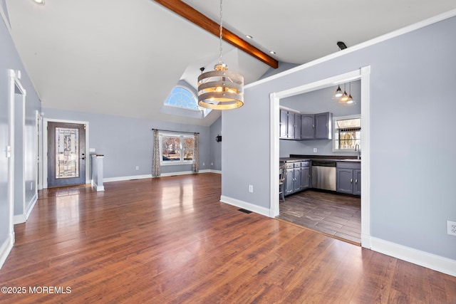 unfurnished living room featuring vaulted ceiling with beams, dark wood-type flooring, visible vents, baseboards, and an inviting chandelier