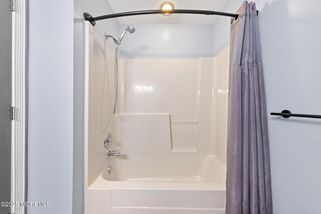 full bath featuring shower / tub combo with curtain