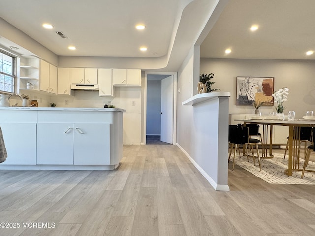 61B Hedge Dr, Lakewood, NJ 08701 - kitchen with visible vents, baseboards, light wood-style flooring, and white cabinetry