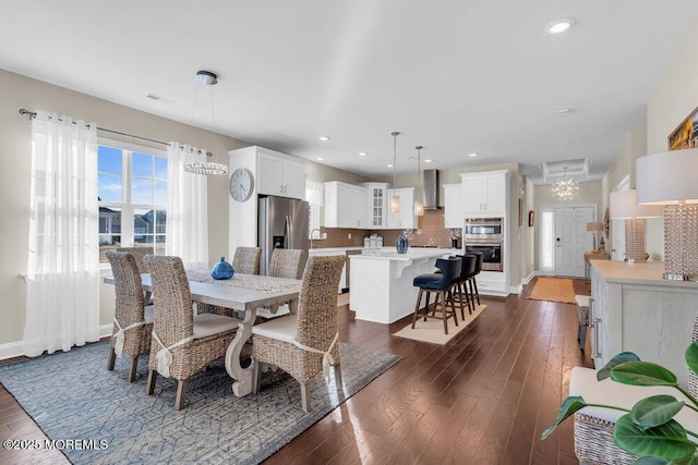 dining space featuring baseboards, dark wood-style flooring, visible vents, and recessed lighting