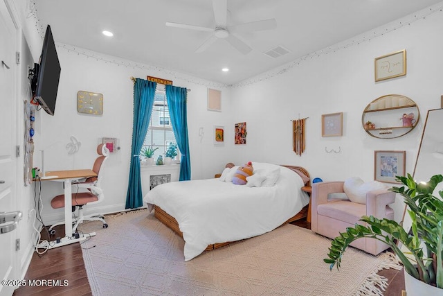 bedroom featuring baseboards, wood finished floors, visible vents, and recessed lighting