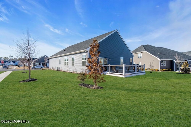 back of house with a lawn and a wooden deck