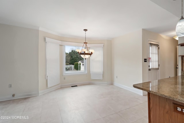 unfurnished dining area with baseboards, visible vents, and a chandelier