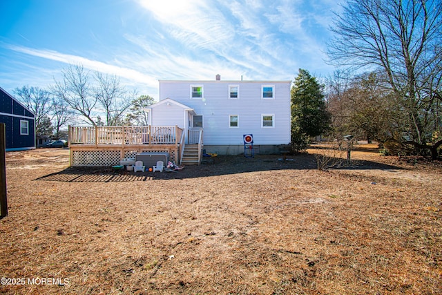 back of house with a deck