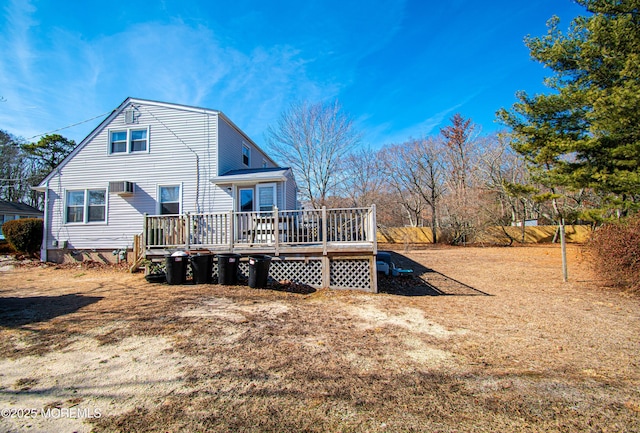 back of house with a deck