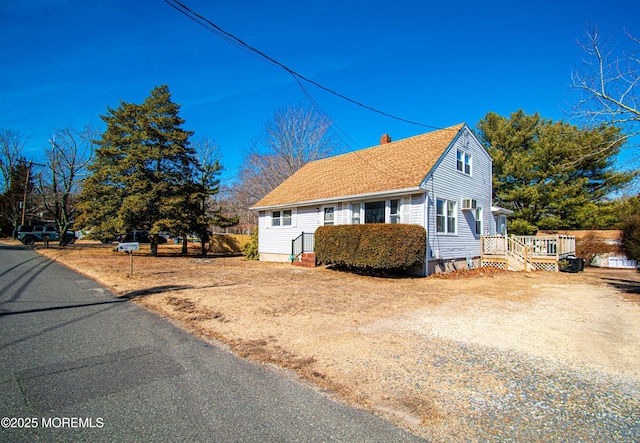 view of front of house featuring roof with shingles and a chimney