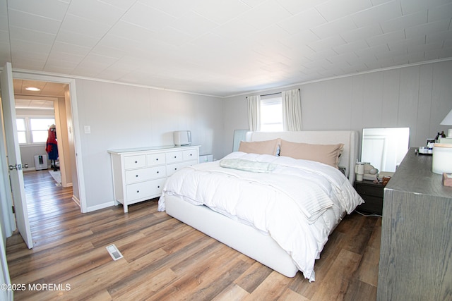 bedroom with baseboards and dark wood finished floors