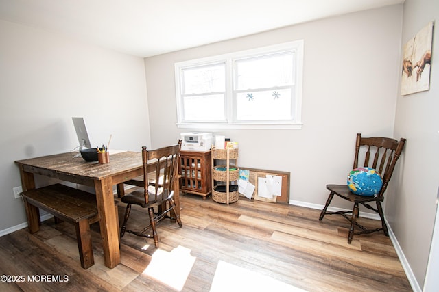 dining area featuring wood finished floors and baseboards