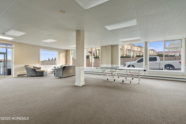 gym featuring a drop ceiling, a baseboard radiator, and carpet flooring