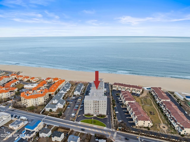 drone / aerial view with a water view and a view of the beach