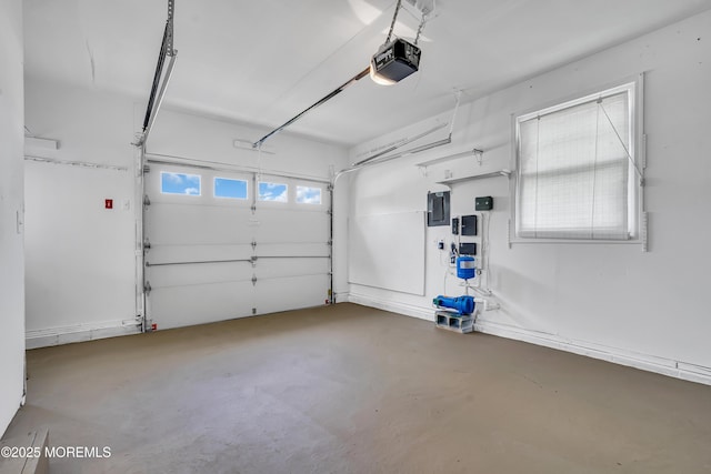 garage with a garage door opener and electric panel