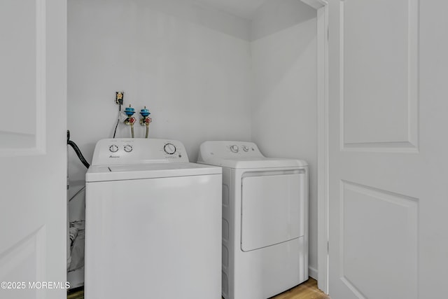 washroom featuring laundry area and washing machine and clothes dryer