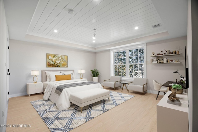 bedroom featuring light wood-type flooring, a raised ceiling, wooden ceiling, and baseboards
