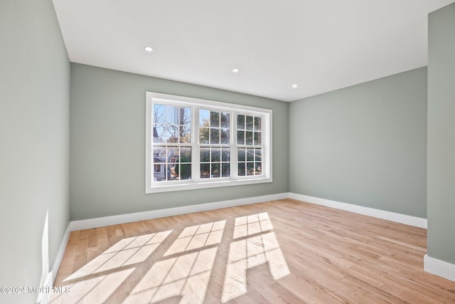 unfurnished room with recessed lighting, light wood-style flooring, and baseboards