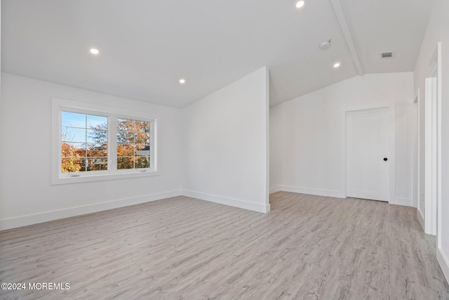 interior space with light wood finished floors, baseboards, vaulted ceiling, and recessed lighting