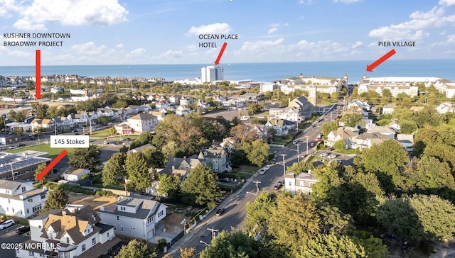 bird's eye view featuring a water view and a residential view
