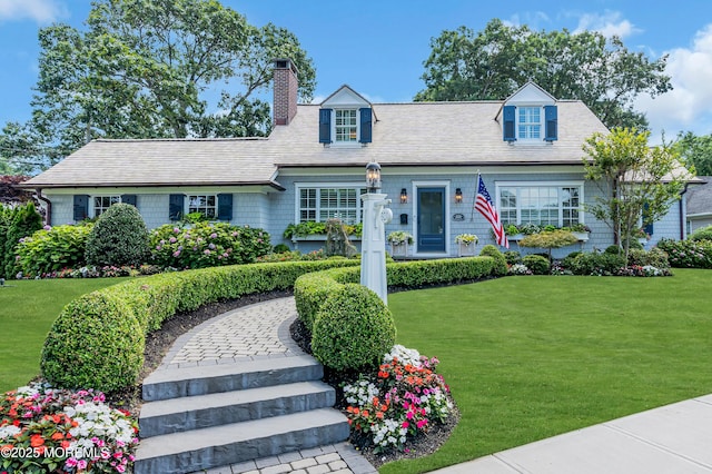 new england style home with a front lawn and a chimney