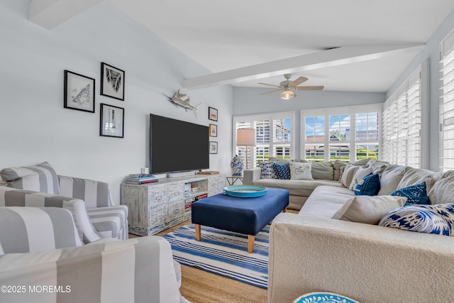 living area with vaulted ceiling with beams and ceiling fan