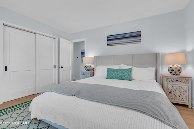 bedroom with light wood-style floors and a closet