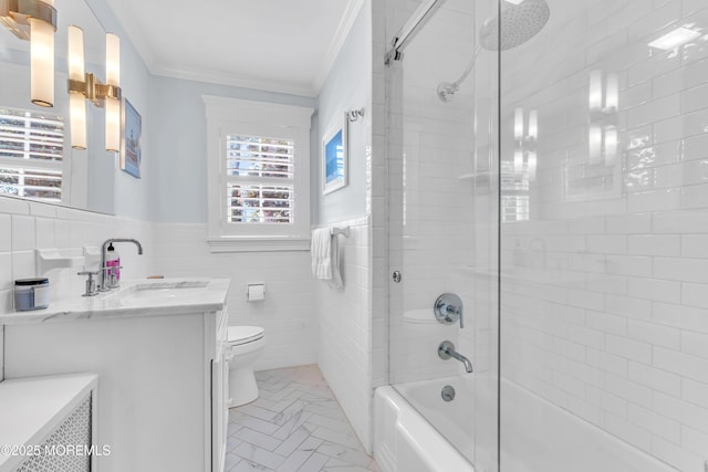 bathroom featuring tile walls, toilet, ornamental molding, washtub / shower combination, and vanity