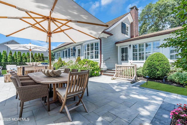 view of patio / terrace featuring outdoor dining space, fence, and an outdoor living space