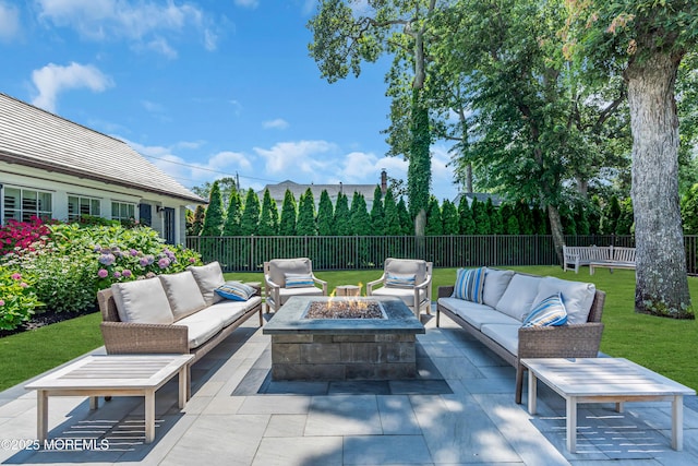 view of patio / terrace with an outdoor living space with a fire pit and a fenced backyard