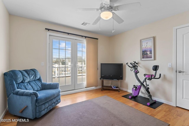 sitting room featuring baseboards, visible vents, french doors, and light wood finished floors