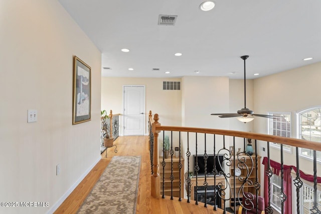 corridor featuring recessed lighting, visible vents, and light wood-style flooring