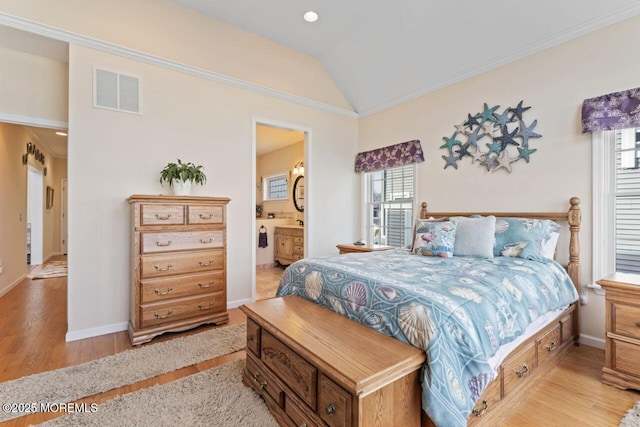 bedroom featuring lofted ceiling, ornamental molding, visible vents, and light wood-style floors