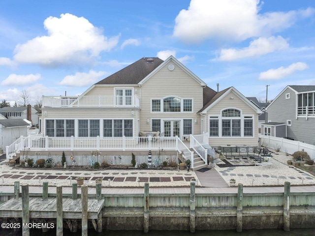 back of property with fence private yard, a patio area, a balcony, and a wooden deck