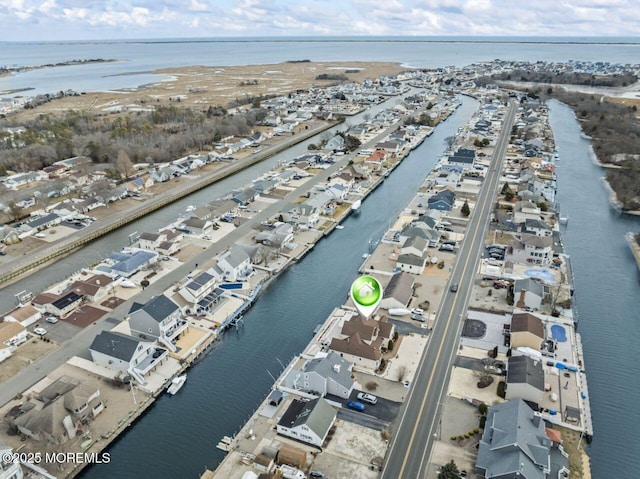 birds eye view of property with a water view and a residential view