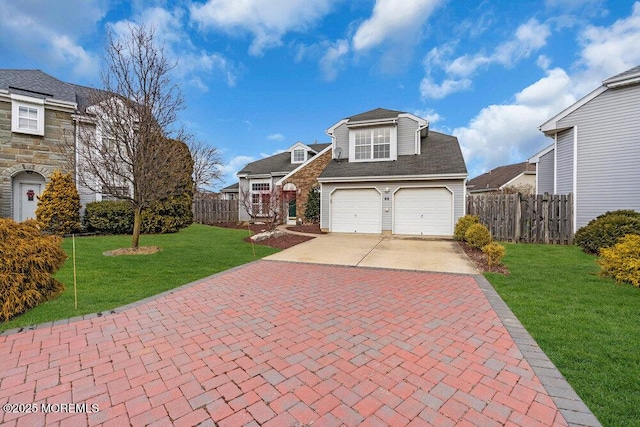 view of front of property with a garage, decorative driveway, fence, and a front lawn