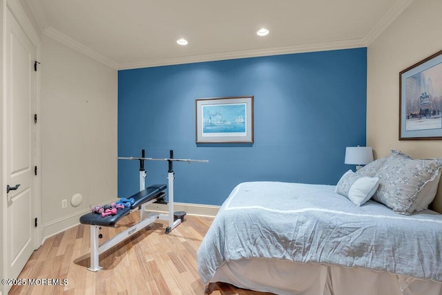 bedroom with crown molding, baseboards, wood finished floors, and recessed lighting