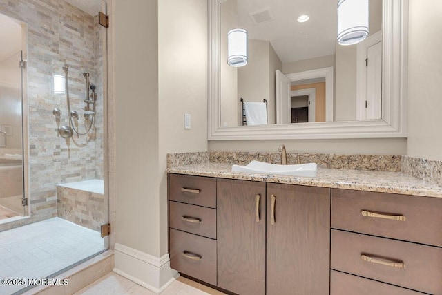 full bathroom featuring visible vents, baseboards, tile patterned floors, vanity, and a shower stall